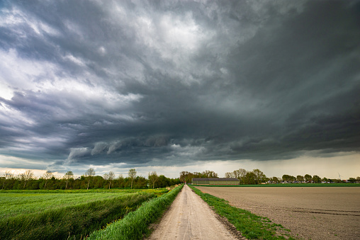 Wide angle view of an ominous looking storm cloud over the Dutch landscape.