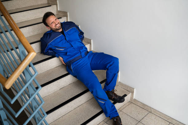 istock Worker Man Lying On Staircase After Slip 1318254576
