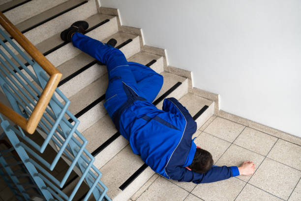 istock Worker Man Lying On Staircase After Slip 1318254630