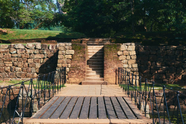 istock Brick Wall Against Trees And Foot Bridge 1318256051