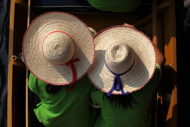 Two people with straw hats in the boat