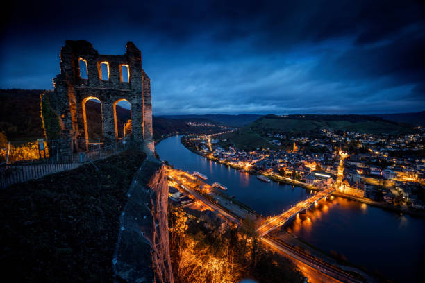 Illuminated townscape of Traben-Trarbach at the Mosel river in Rhineland-Palatinate, Germany. Ruin of castle Grevenburg in the foreground. Traben-Trarbach at the Middle Moselle-valley is a town in the Bernkastel-Wittlich district in Rhineland-Palatinate,