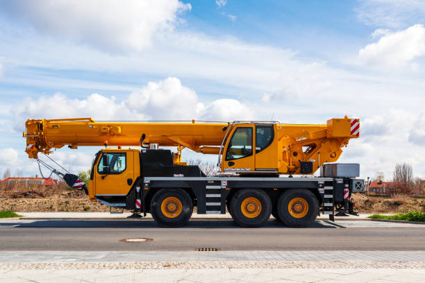 istock yellow heavy duty mobile crane parked on the roadside. 1318258124