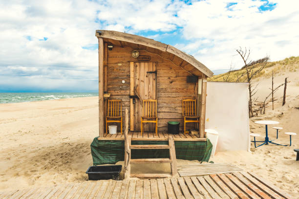 istock Beautiful wooden sauna on a sand beach 1318259931