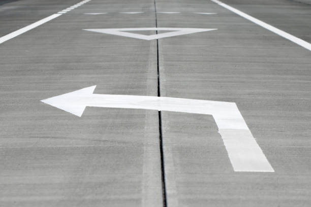 istock White arrow on the highway. Left turn. Traffic regulation. 1318262209