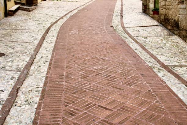istock Bricks paved path in old street in italy 1318264669