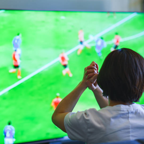 istock Japanese middle aged woman watching TV program 1318265376