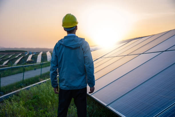istock Engineer standing in solar power station looking sunrise 1318269092