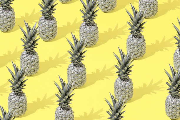istock Creative summer pattern background with gray pineapple on a yellow background. Minimal style. Creative summer or food concept. 1318269445