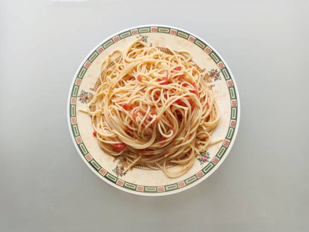 Traditional italian macaroni pasta with grilled tomato and oregano