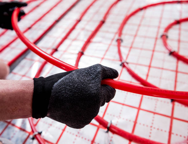 istock Pipefitter install system of underfloor heating system at home 1318278857
