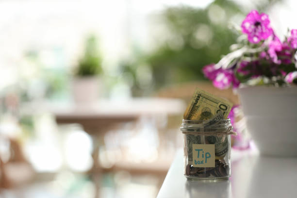 istock Glass jar with tips on table indoors. Space for text 1318279202