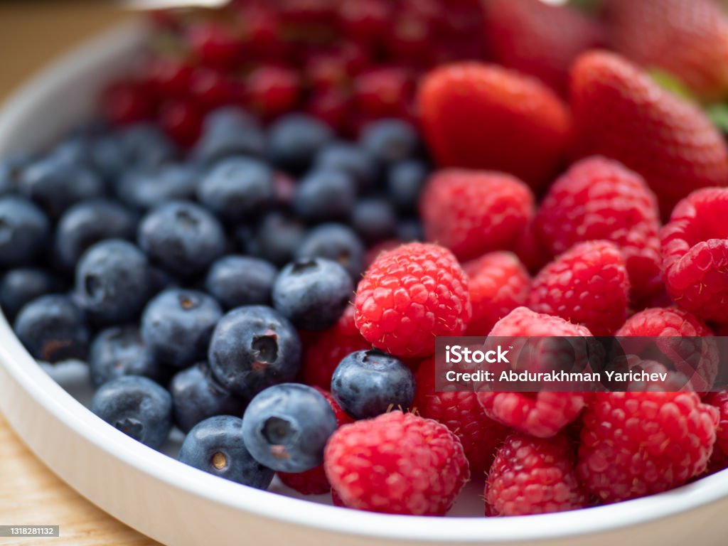 different berries on a plate different berries on a plate raspberries blueberries strawberry Antioxidant Stock Photo