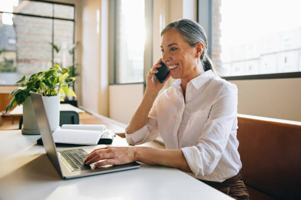 istock Mature professional talking on cell phone 1318282348