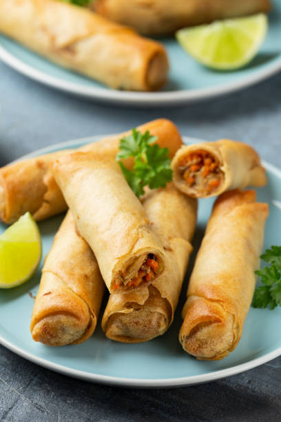 istock Fried spring rolls with sweet chili sauce and lime on plate 1318283275