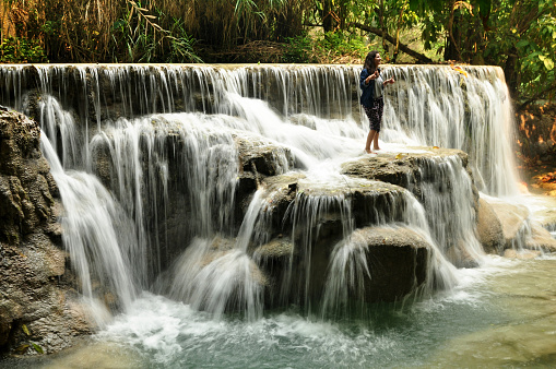 Laotian people and foreign travelers travel visit and play swimming shallow water pool atop of Tat Kuang Si Waterfalls or Kuang Xi Falls at Luangprabangon Lao city April 8, 2016 in Luang Prabang, Laos