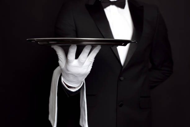 Butler with tray on black background, closeup Butler with tray on black background, closeup people banque stock pictures, royalty-free photos & images