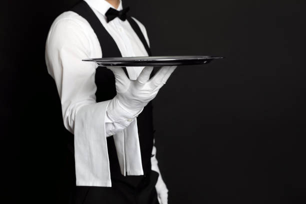 istock Butler with tray on black background, closeup 1318289240
