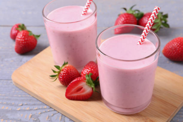 istock Delicious strawberry drink on light grey wooden table 1318289347