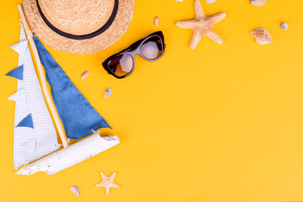 istock Beach accessories: glasses and hat with shells and sea stars on a colored background 1318289417