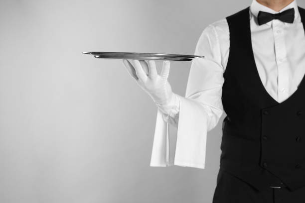 istock Butler with tray on light grey background, closeup. Space for text 1318289527
