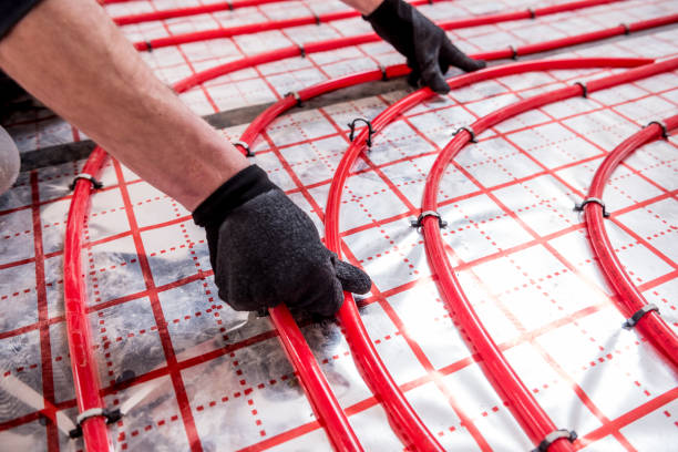 istock Pipefitter install system of underfloor heating system at home 1318296543