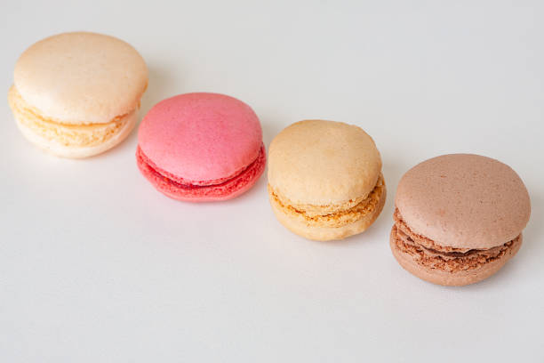 istock Fragrant chocolate, coffee and raspberry french macaroons close up on white 1318297685