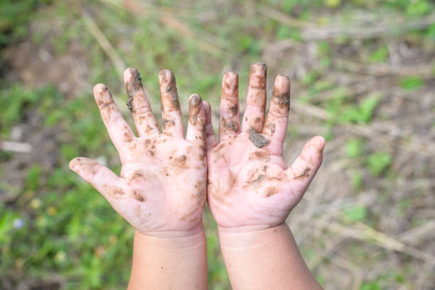 istock Close up of hands with mud 1318297837