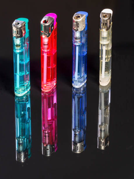 istock Four gas lighters in different colours on a black reflecting background 1318300436