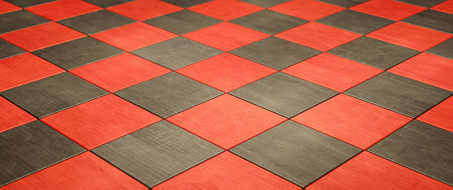 Close up on a black and red artificial tiled floor - low angle wide horizontal composition