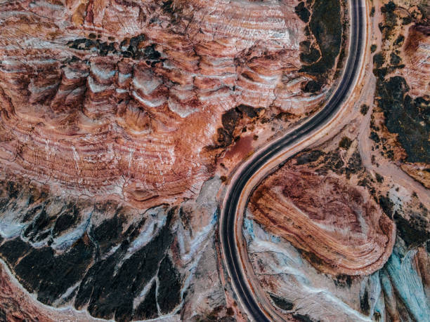 aerial view of rural road through danxia landform - gobi desert imagens e fotografias de stock
