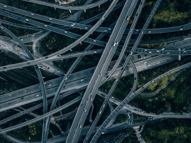 aerial view of complex overpass and busy traffic - traffic roundabout imagens e fotografias de stock