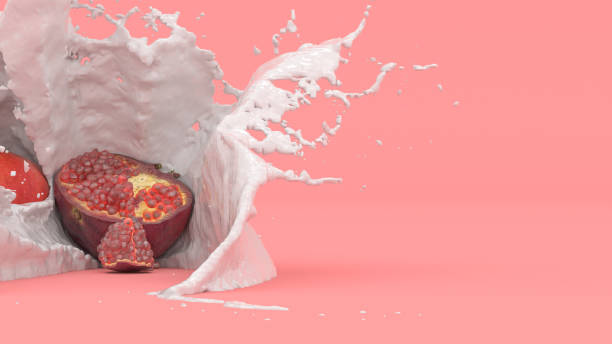 pomegranate fruit on a red background in a splash of milk