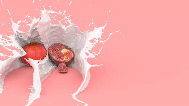 pomegranate fruit on a red background in a splash of milk