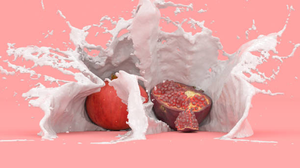 pomegranate fruit on a red background in a splash of milk