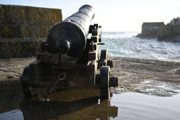 old cannon pointing towards the ocean