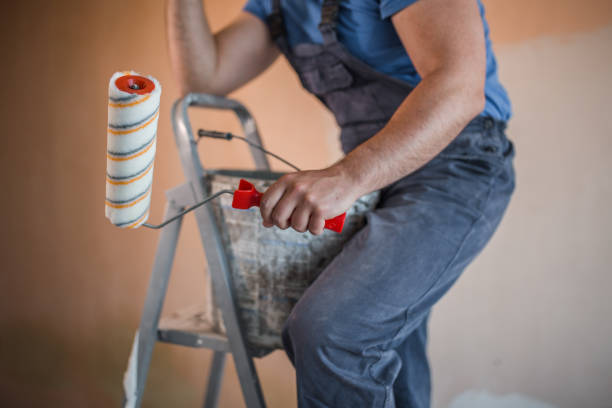 istock Close-up of painter with paint roller and bucket 1318305000