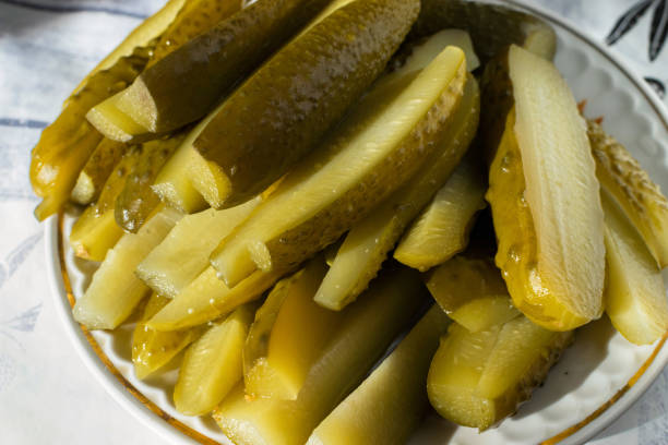 istock Sliced green pickles on a plate on the table 1318305738