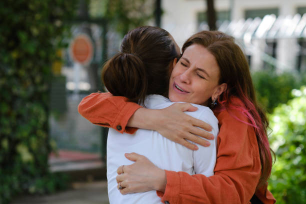 istock Happy women hugging each other 1318310169