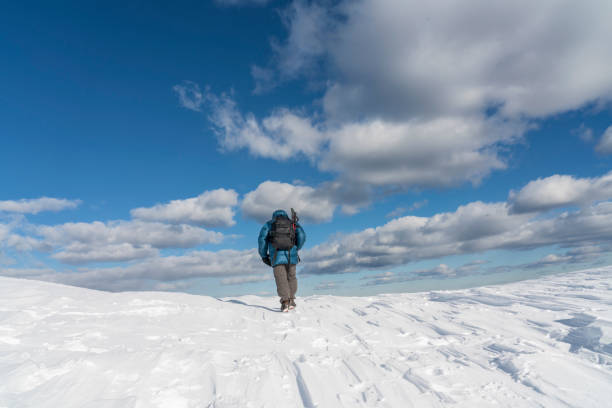 istock Men at Big Pasture Plateau, Velika Planina in winter 1318310514