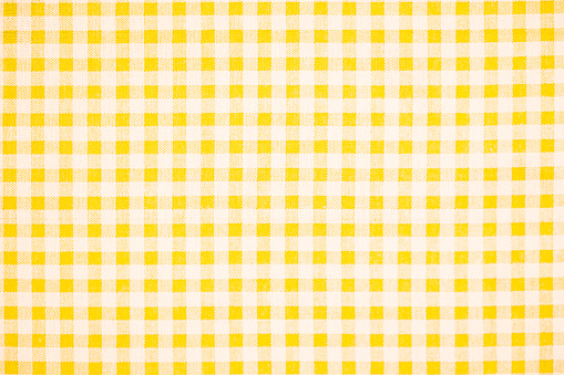 Gingham pattern in yellow and white, closed up texture of yellow and white for background. Picnic table cloth.