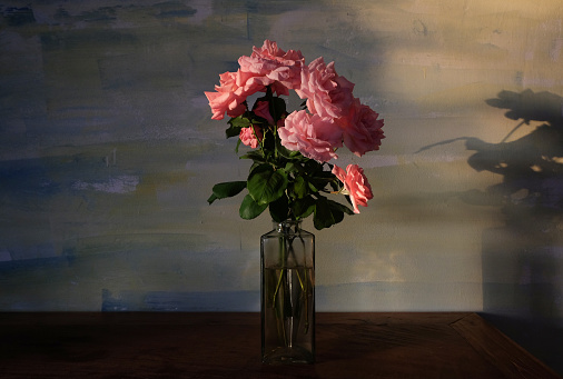 Beautiful rose in a glass vase. Beautiful flower from home garden on a dark table. A background art beauty black blossom bokeh bouquet bright bunch closeup colorful day floral flowers gift green holiday isolated leaf life lisianthus love mother mothers nature petal pink plant red romantic roses spring still summer wedding