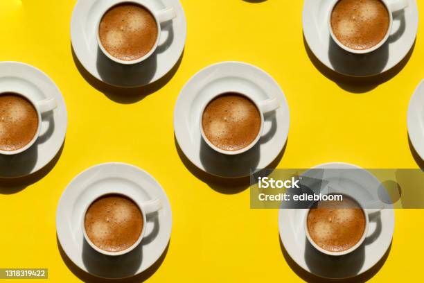 Pattern Made Of Cup Of Cappuccino On Yellow Background Stock Photo - Download Image Now