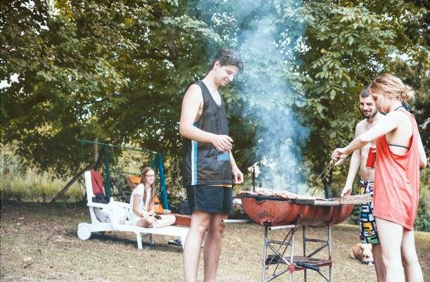 istock Friends camping and having a barbecue in nature 1318322388