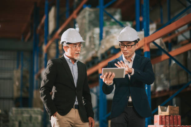 istock asian chinese management having discussion at warehouse with white hardhat using digital tablet 1318322404