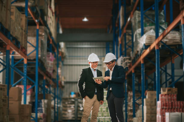 istock asian chinese management having discussion at warehouse with white hardhat using digital tablet 1318322408