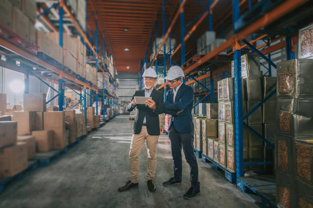 istock asian chinese management having discussion at warehouse with white hardhat using digital tablet 1318322417