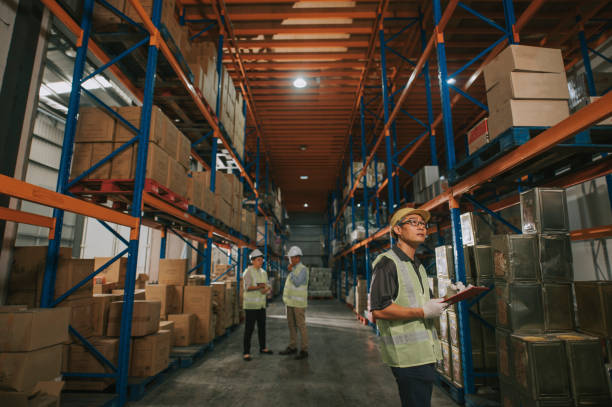 istock asian chinese warehouse worker looking checklist and management having discussion with warehouse worker at warehouse with white hardhat 1318322428