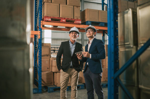 istock asian chinese management having discussion at warehouse with white hardhat using digital tablet 1318322435