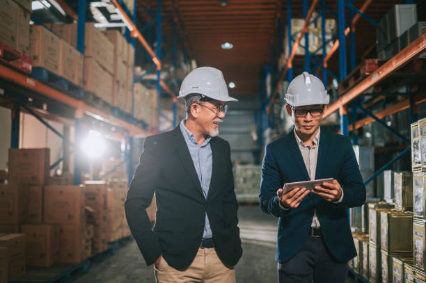 istock asian chinese management having discussion at warehouse with white hardhat using digital tablet 1318322443